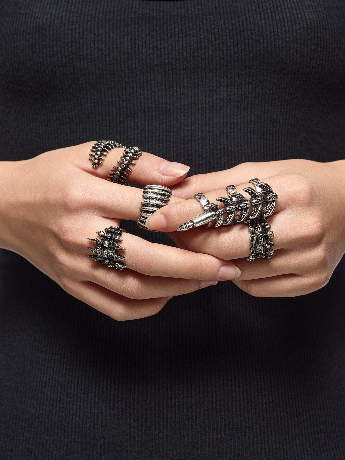 Set of 5 silver rings with centipede, spine and spike designs.