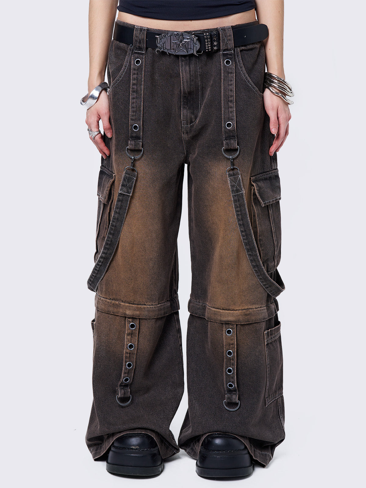 Black washed multi pocket cargo jeans with brown overdye. Featuring detachable-leg with zipper and all over straps and D-rings details.