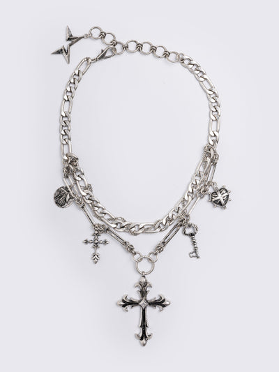 Silver chunky layered necklace featuring cross, key and medallion pendants.