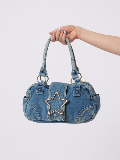 A Y2K-inspired denim handbag with star by Minga London. Trendy and compact for a fashionable and nostalgic touch to your look.