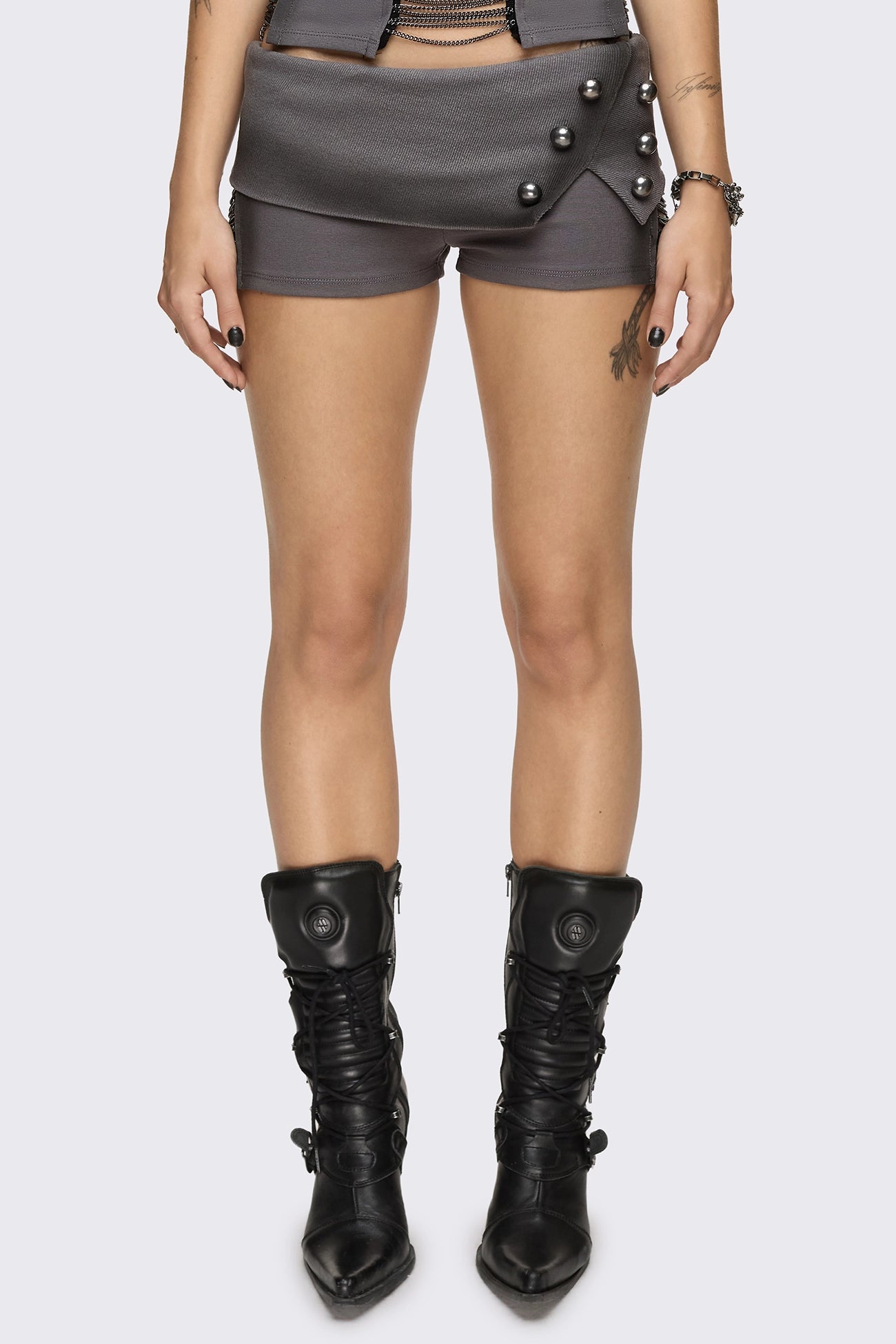 Grey washed jersey hot pants with side cutouts, silver chains and a studded fold-over low rise waistband.