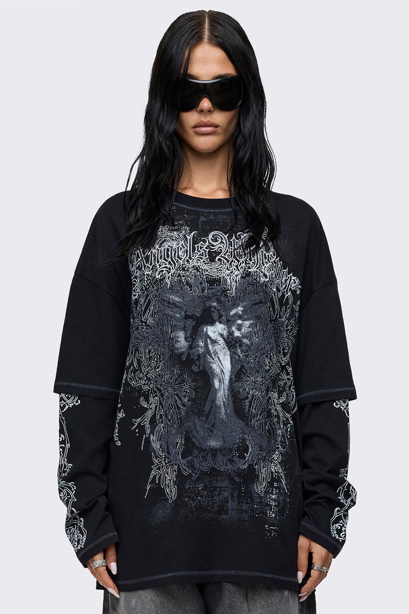 Black layered long sleeve T-shirt with Angels Whisper graphic print, print sleeves, contrast stitching and relaxed fit.