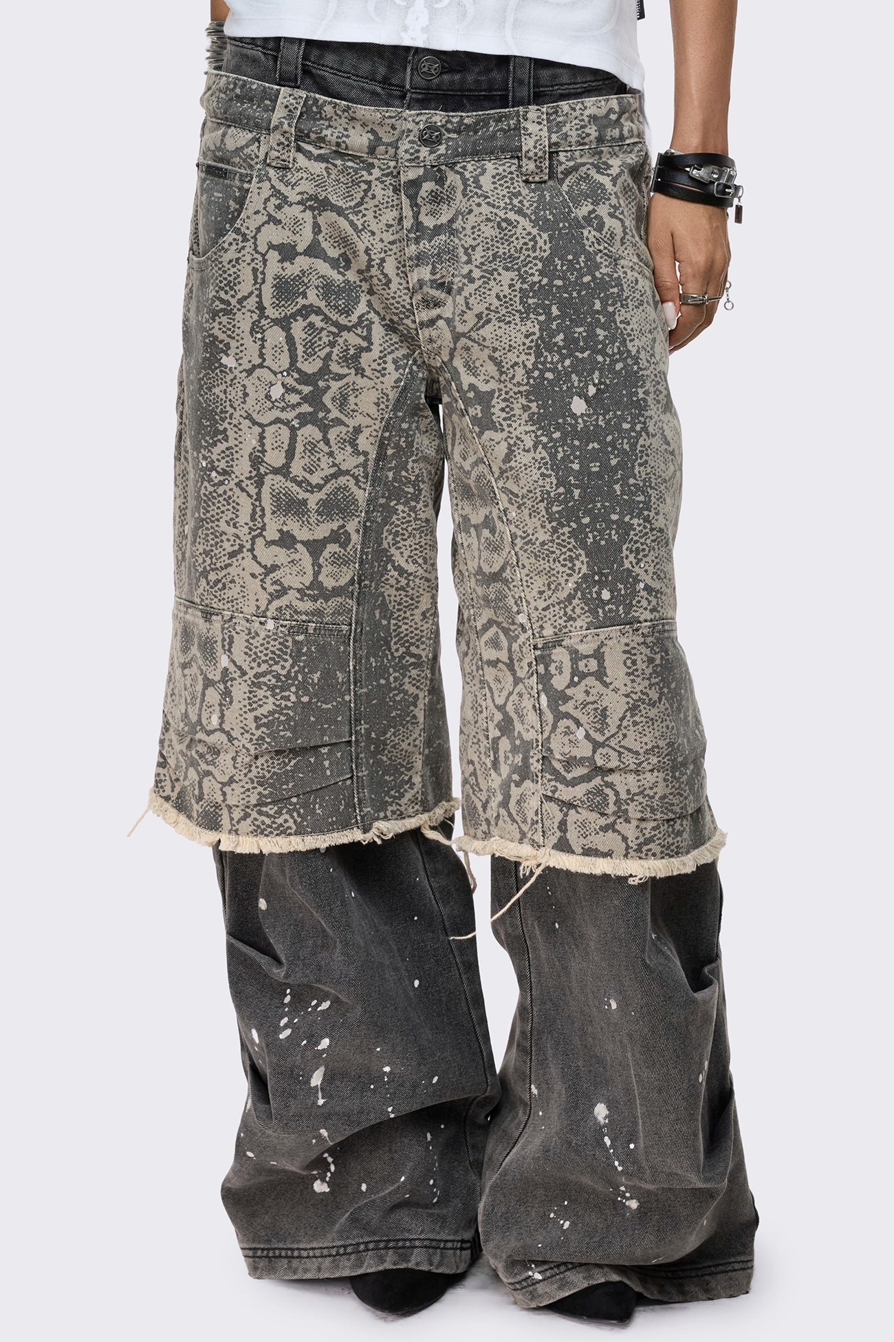 Grey snake print layered baggy jeans with paint splatter, low rise waist, wide leg fit and frayed raw hem.