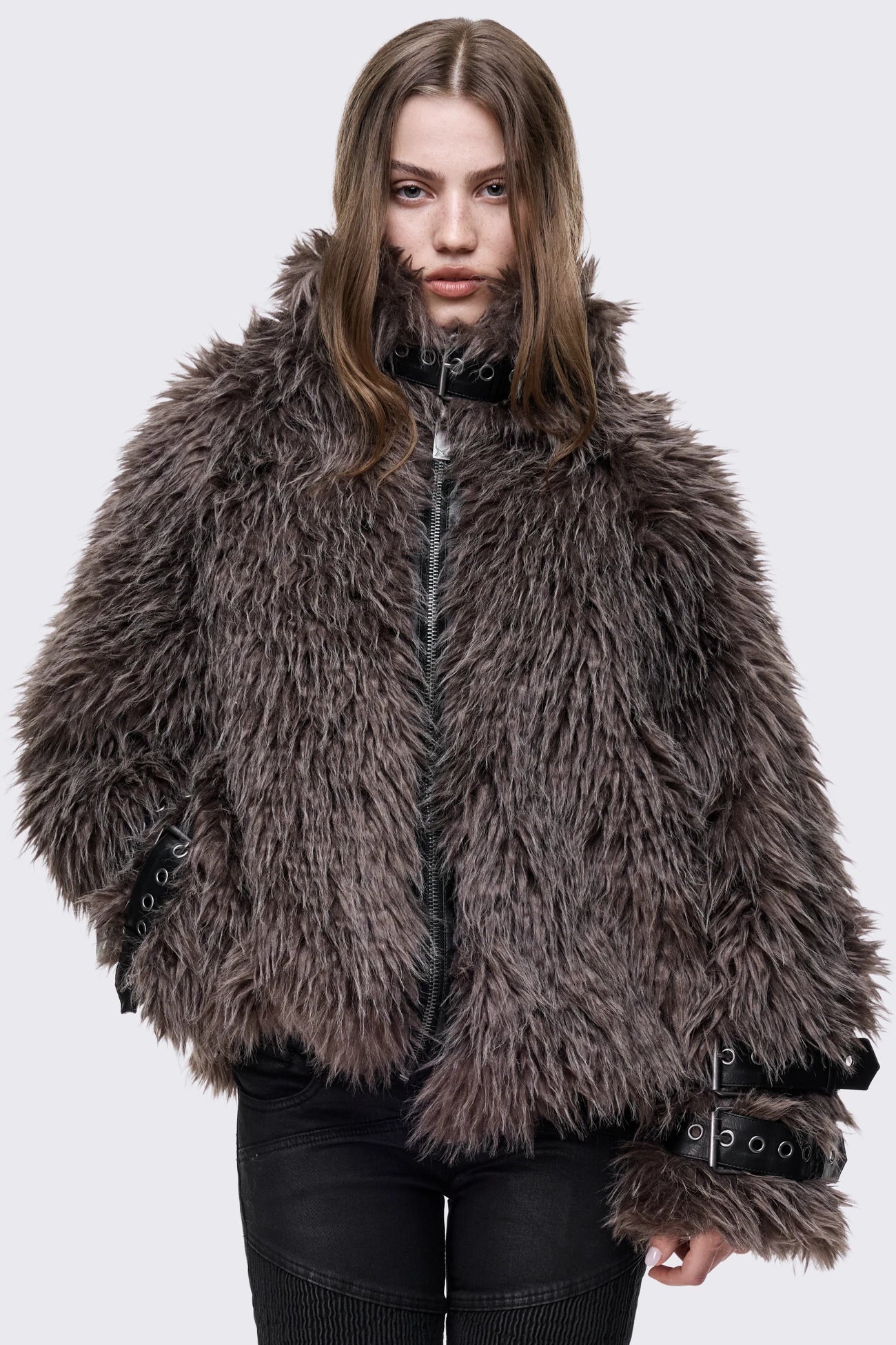 Voluminous oversized brown faux fur jacket featuring long-pile shaggy texture and a high-neck funnel collar.