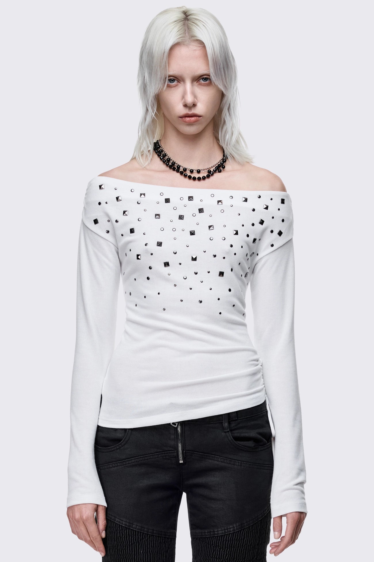 White off-shoulder long sleeve top and stud details.  