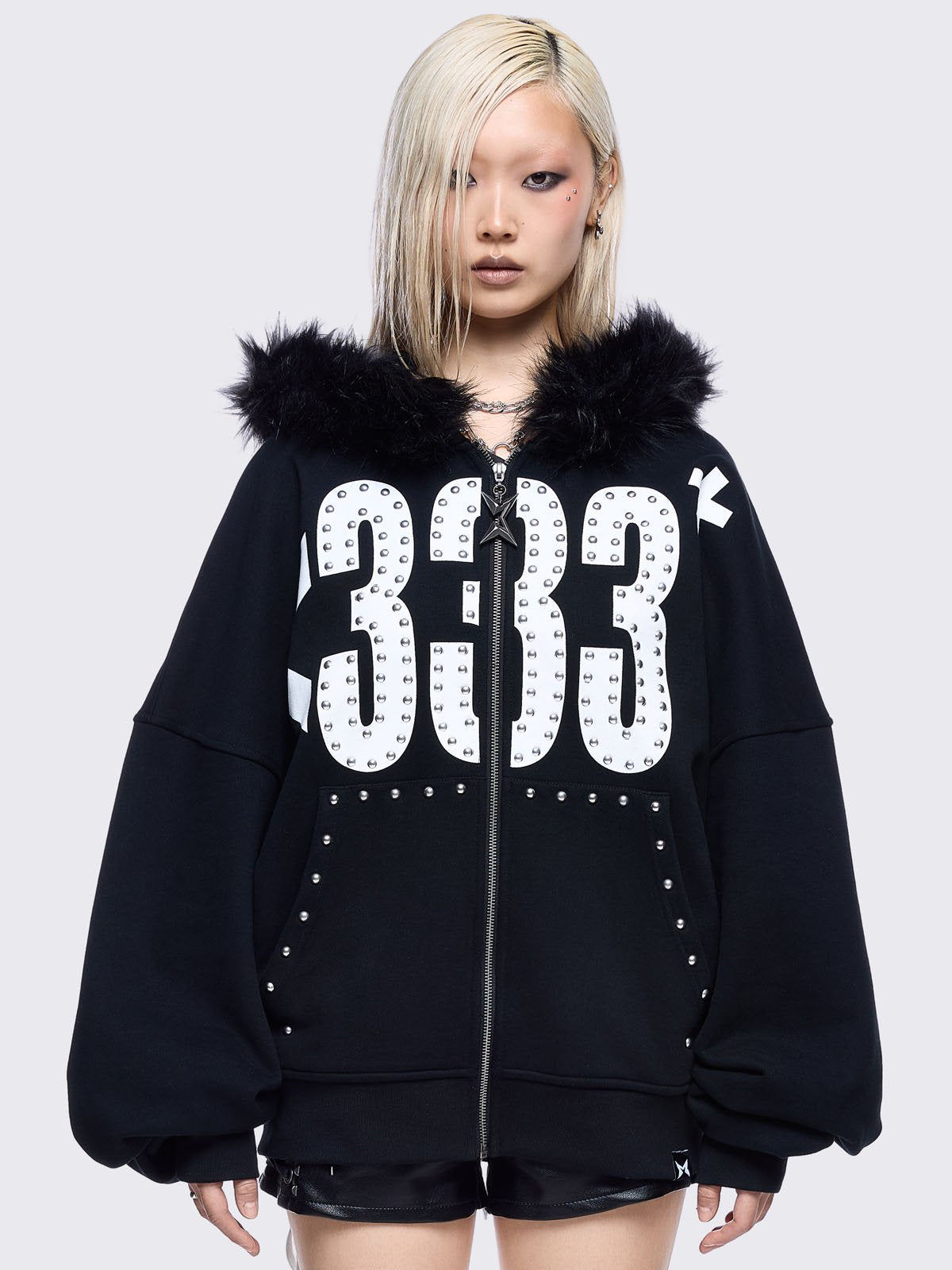Black zip up hoodie jacket with faux fur hood and emoji heart front print in white.
