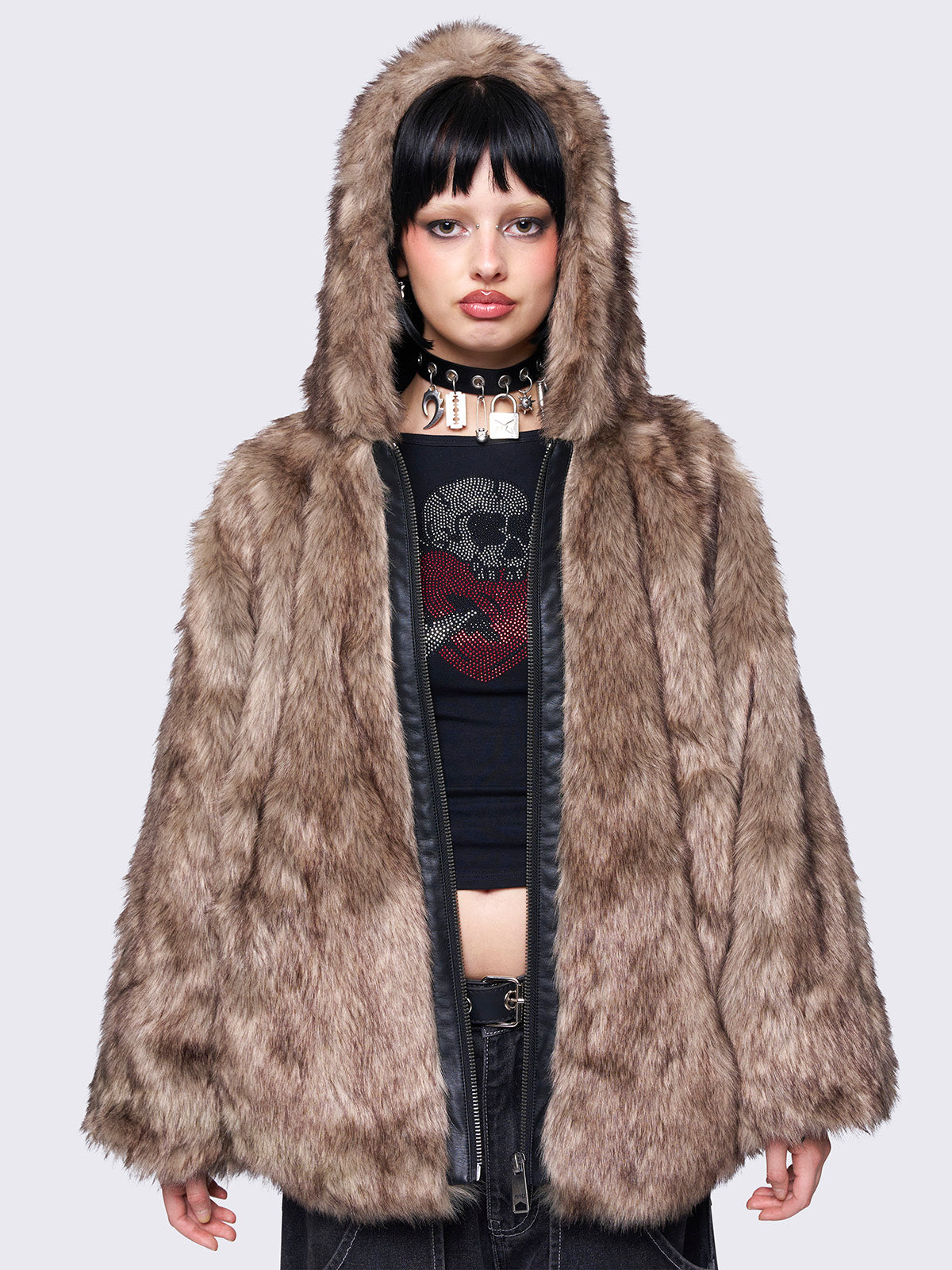 Brown faux fur hooded jacket with zip fastening and side pockets. Features a loose fit for a cozy, stylish look.