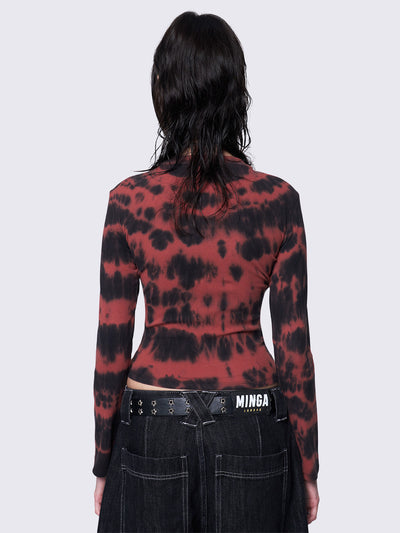 Asymmetric long sleeve top with black and red tie-dye pattern, cross patch with safety pins, silver eyelets at neckline and armhole, slim fit.