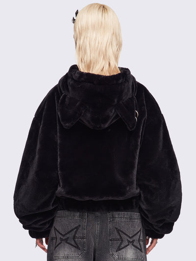 Black oversize faux fur jacket with cat ear hood with piercing details.