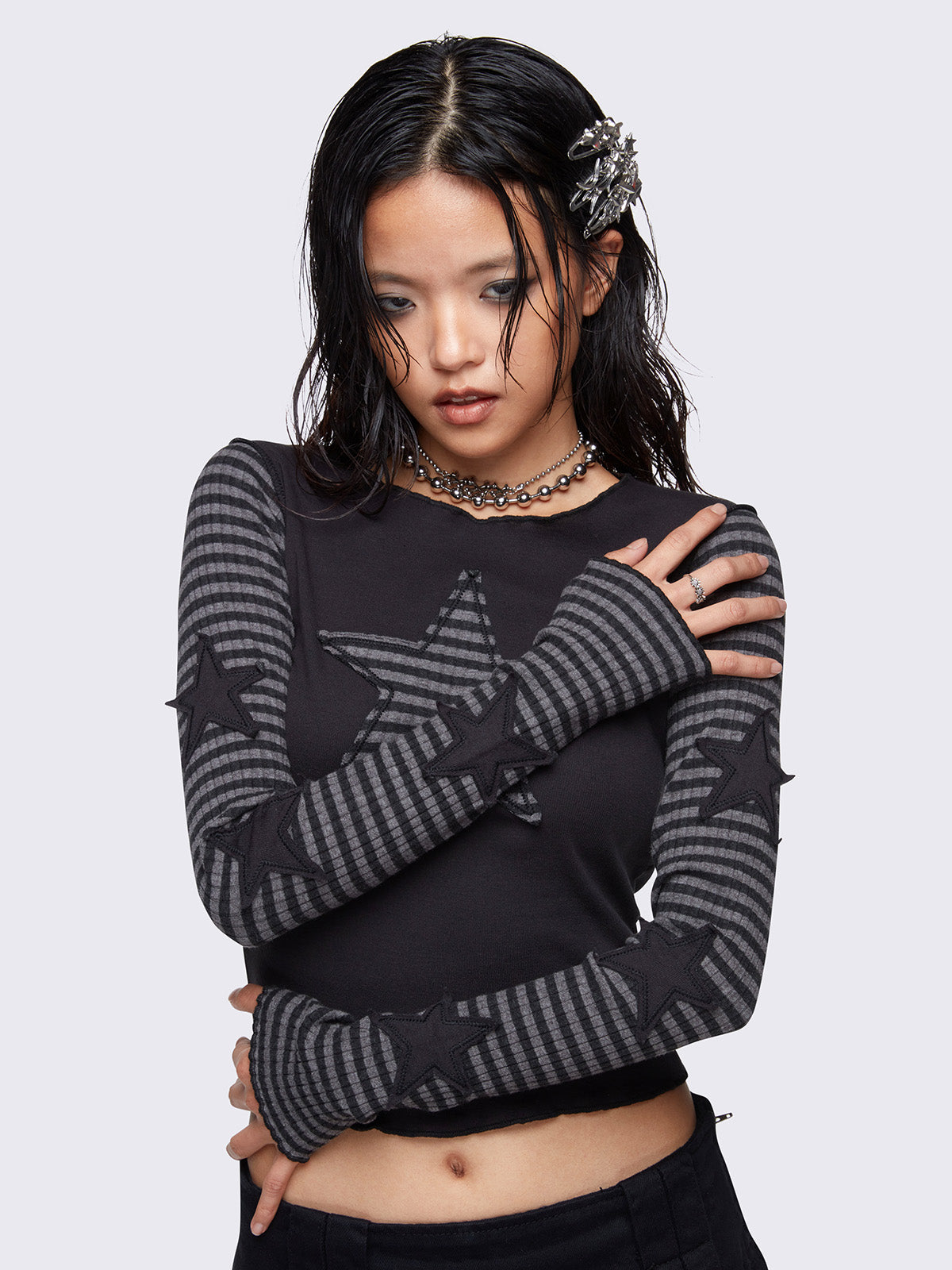 Black long sleeve top with grey striped sleeves and striped star patch on front and black stars on sleeves