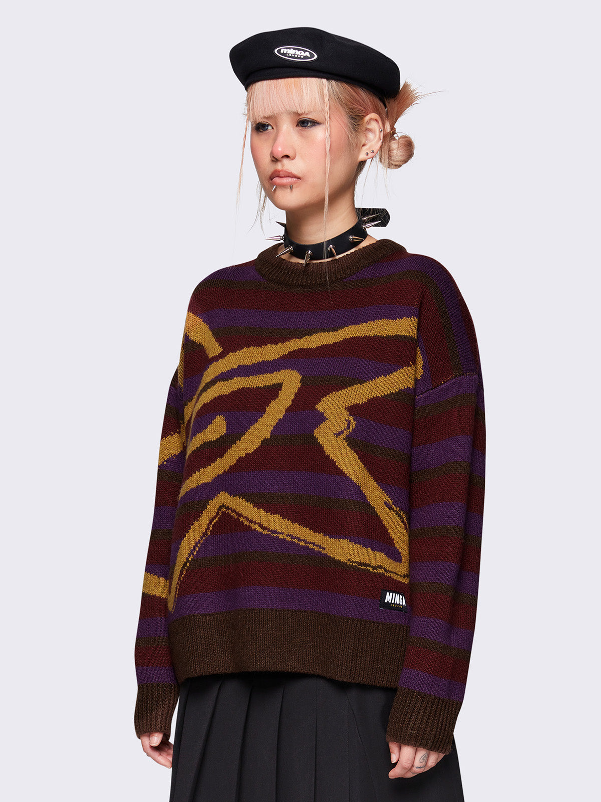 Striped knit jumper in brown, burgundy and purple with a swirl star design in orange and a loose fit.