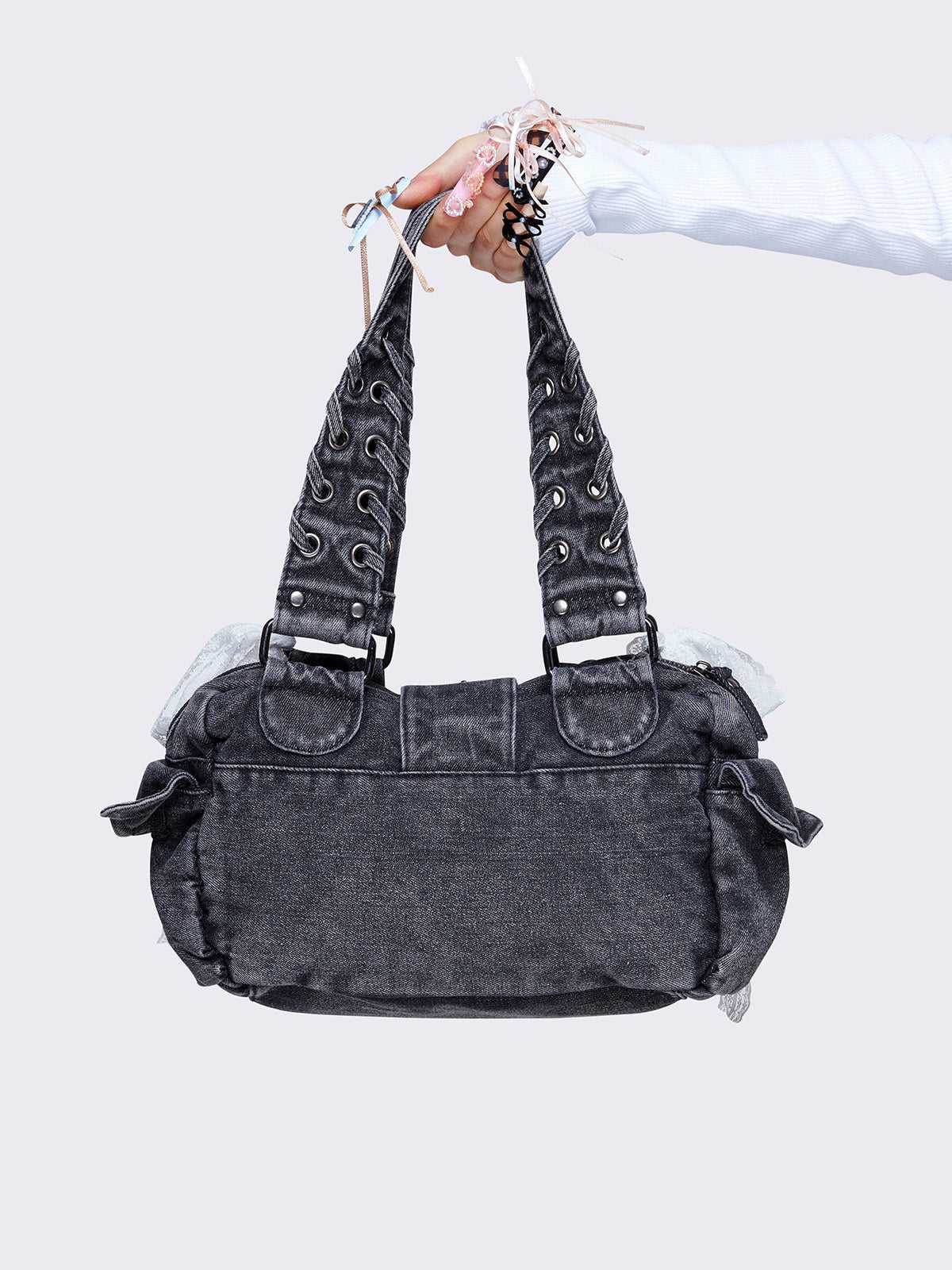 Washed grey shoulder bag with lace-up strap details, lace bow accents, front pockets, and a cute teddy bear keychain. Perfect for Y2K and alternative fashion styles.