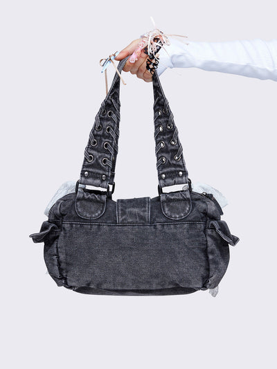 Washed grey shoulder bag with lace-up strap details, lace bow accents, front pockets, and a cute teddy bear keychain. Perfect for Y2K and alternative fashion styles.