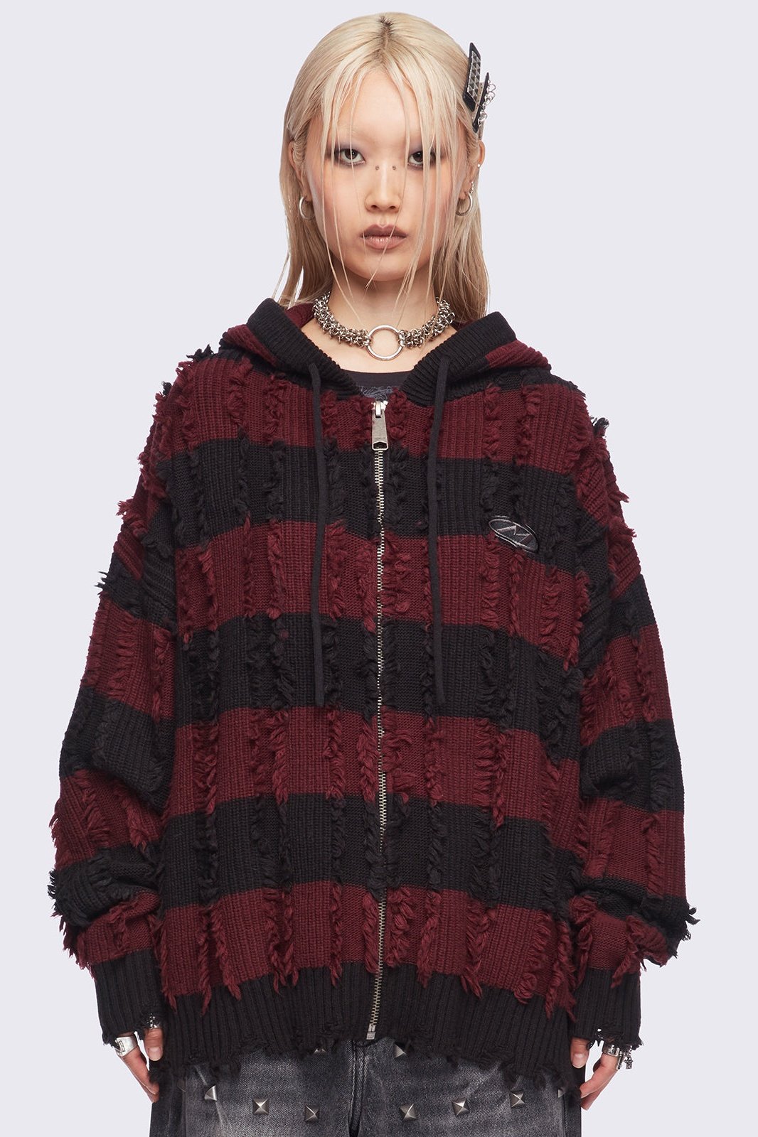 Hooded chunky knit cardigan in black and red stripes with distressed details.