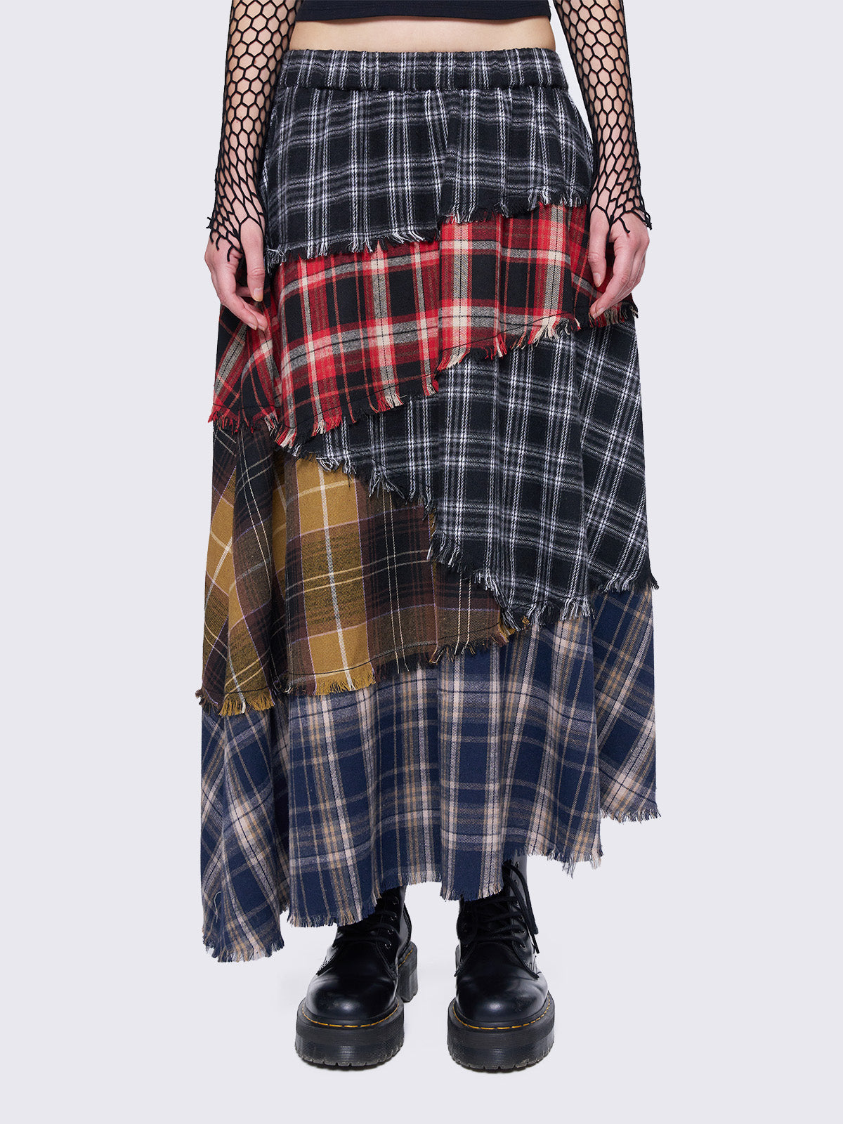 Patchwork tiered maxi skirt with multi-colored plaid panels and frayed trims.