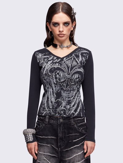 Black washed v-neck ribbed top featuring a fleur-de-lis graphic front print and silver stud details.