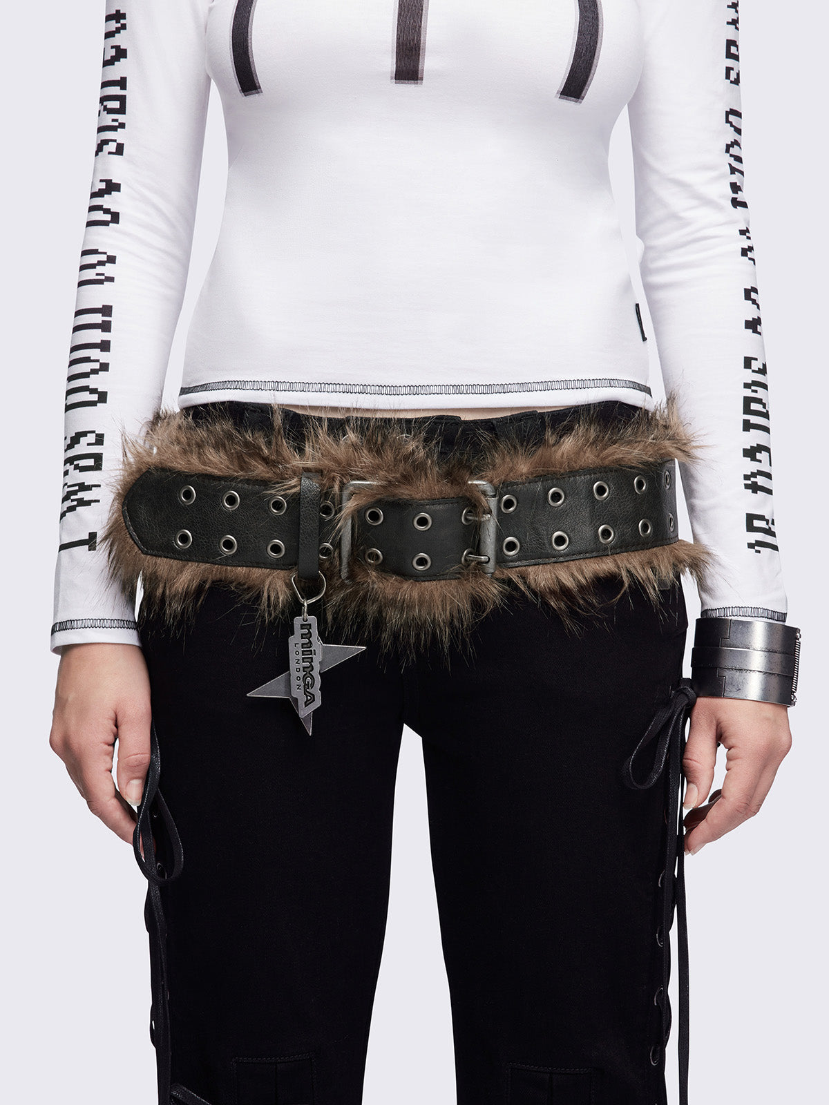 Black double grommet belt featuring brown faux fur trim.