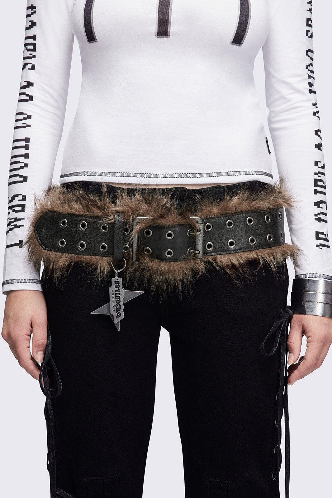 Black double grommet belt featuring brown faux fur trim.