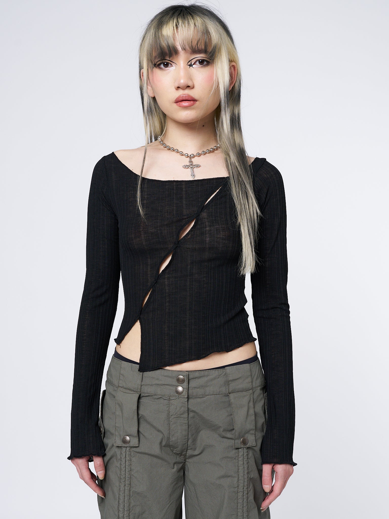 A grunge-inspired long sleeve top with edgy asymmetrical cut-out details. Perfect for a rebellious and bold style statement.