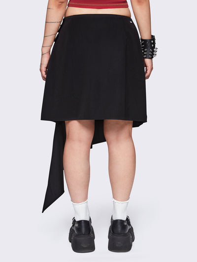 Pleated asymmetric midi skirt in black with double buckle and wrap effect.