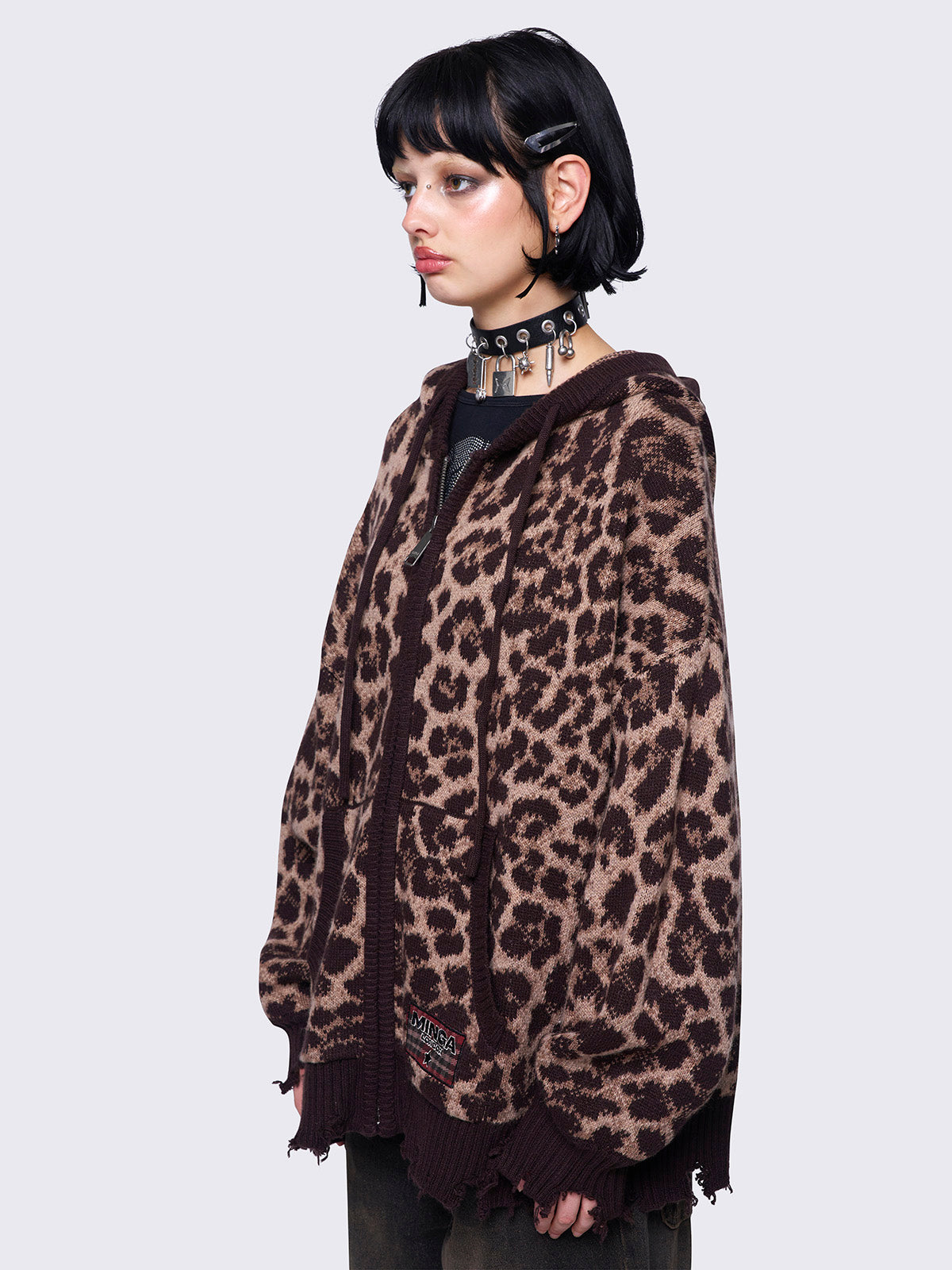 Leopard print knitted zip-up cardigan featuring a hood and distressed ribbed details for a trendy and cozy look