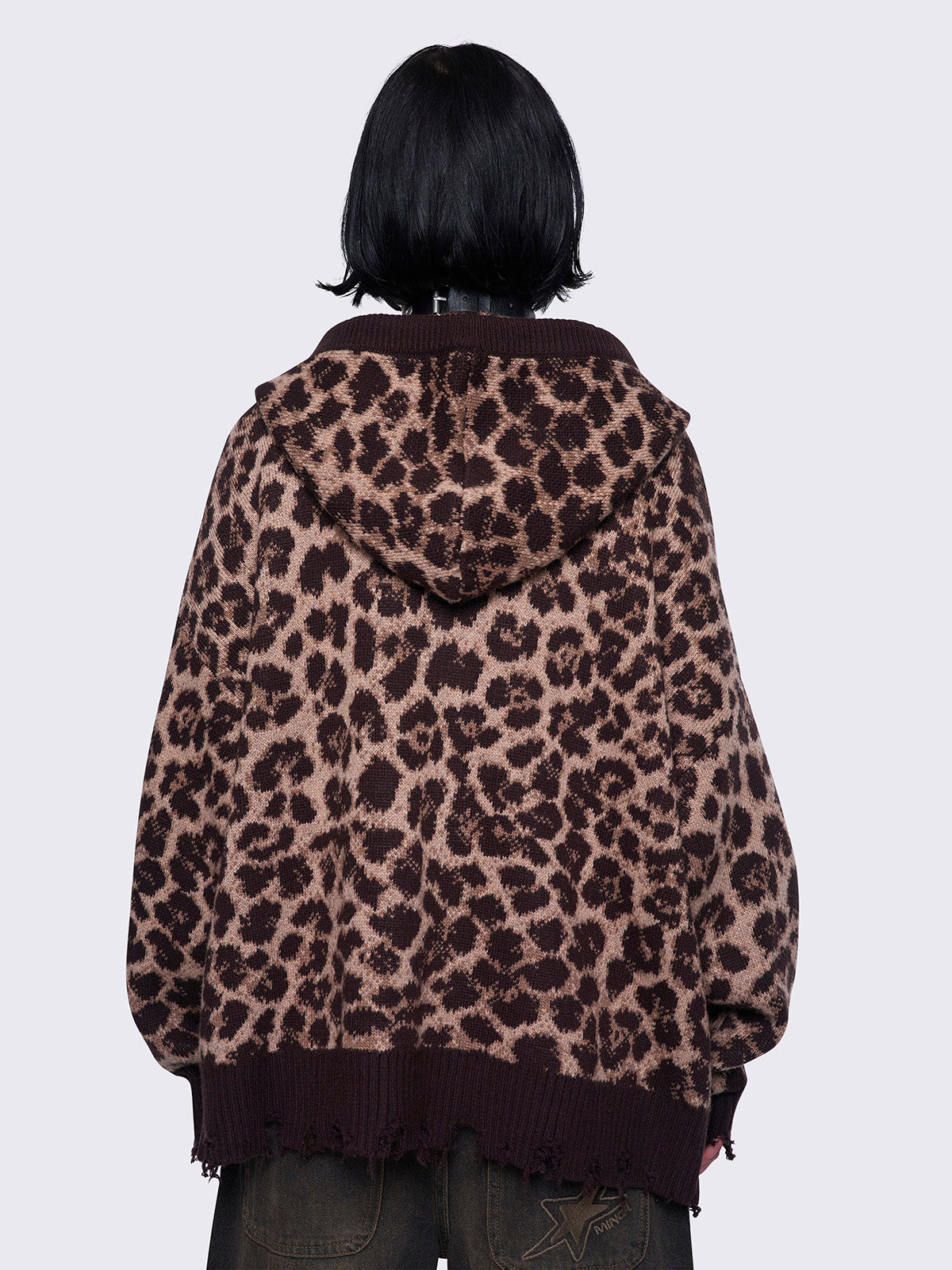 Leopard print knitted zip-up cardigan featuring a hood and distressed ribbed details for a trendy and cozy look