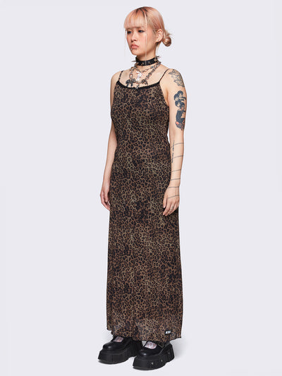 Maxi dress in leopard print featuring a lace trim neckline, adjustable cami straps and a mesh overlay. The dress is fully lined and falls to a maxi length.