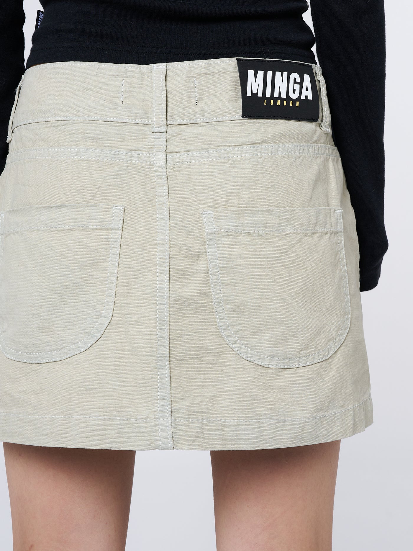 Embrace the Y2K vibes with this trendy and versatile beige cargo-inspired mini skirt. Perfect for a fashionable and nostalgic look.