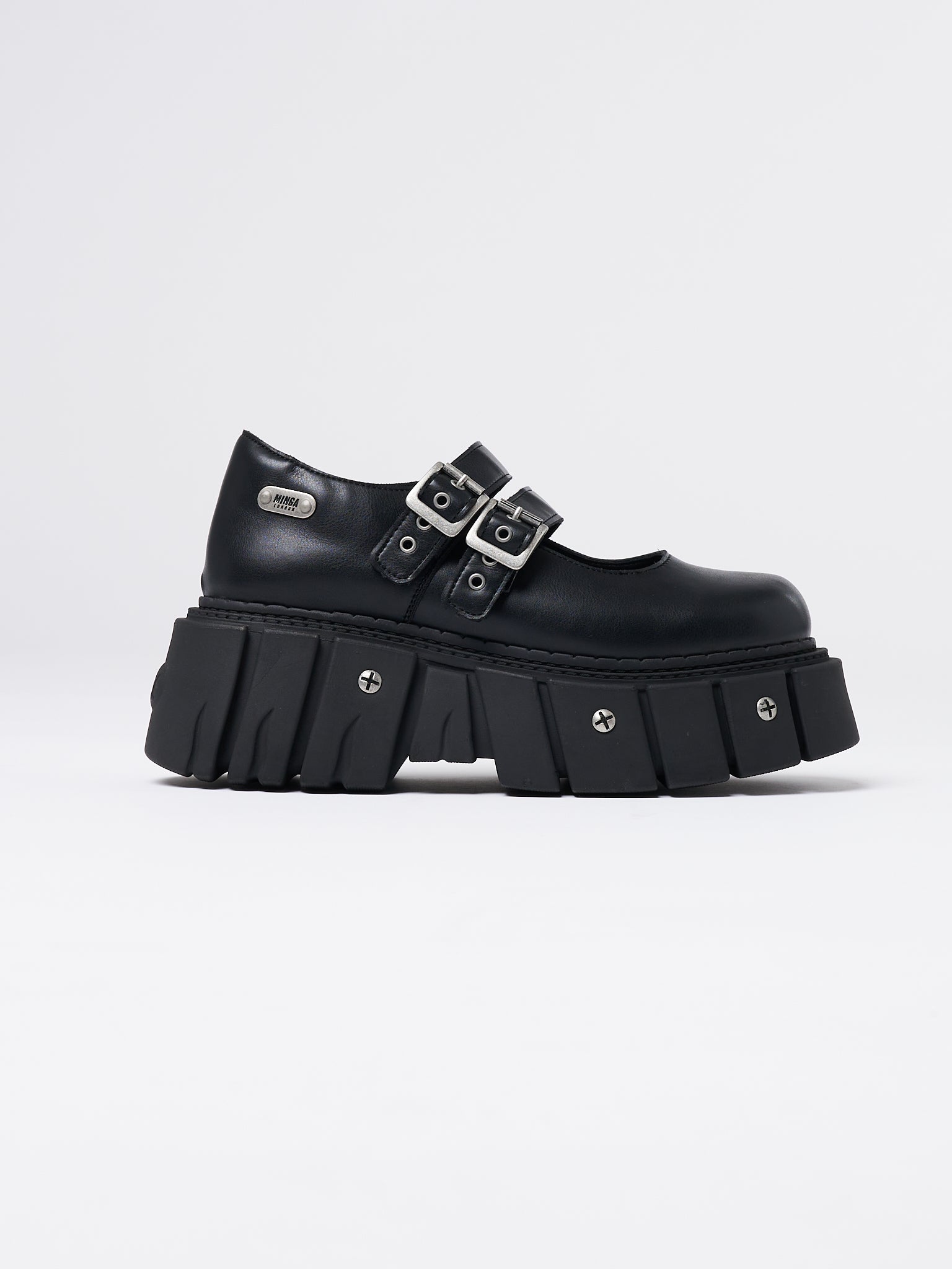Black chunky platform Mary-Janes by Minga London. Edgy and stylish footwear with a comfortable fit. Perfect for adding a bold touch to any outfit.