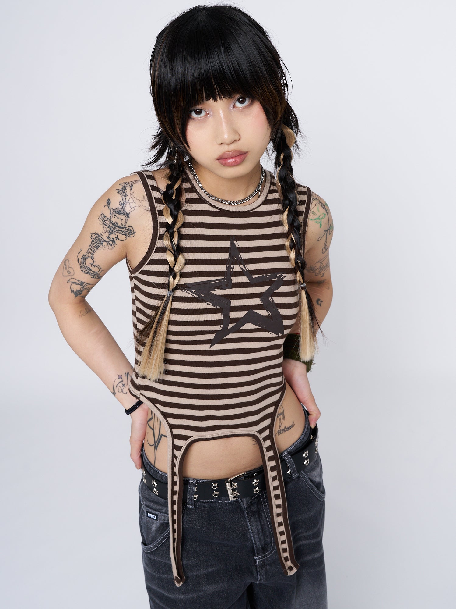 Fashion-forward and versatile vest featuring a stylish striped pattern and eye-catching star print.