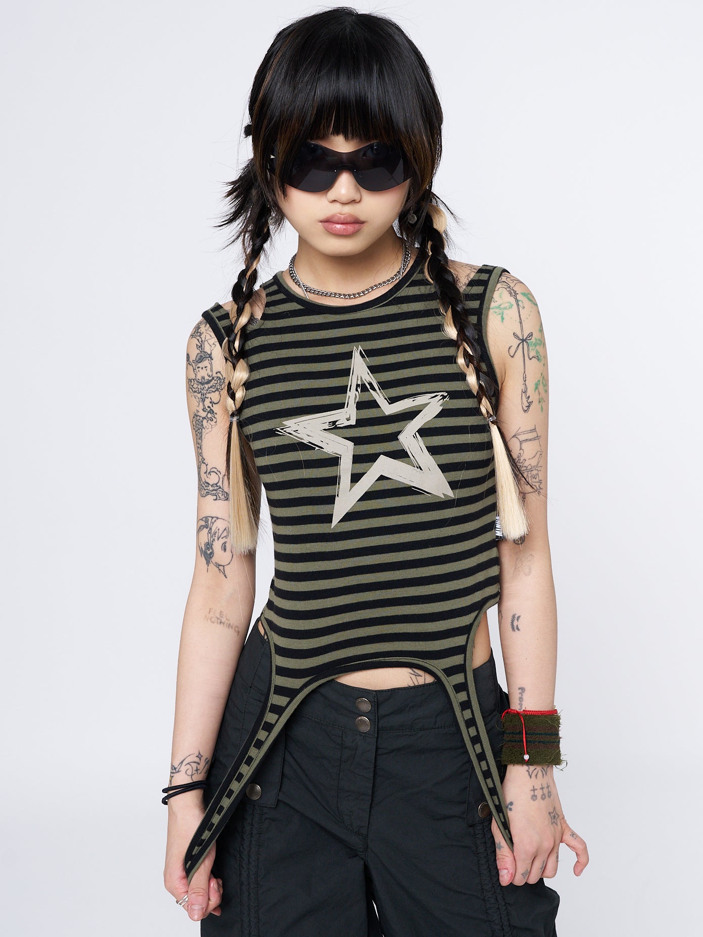 Vibrant and trendy striped green top with straps and a captivating star sketch design.