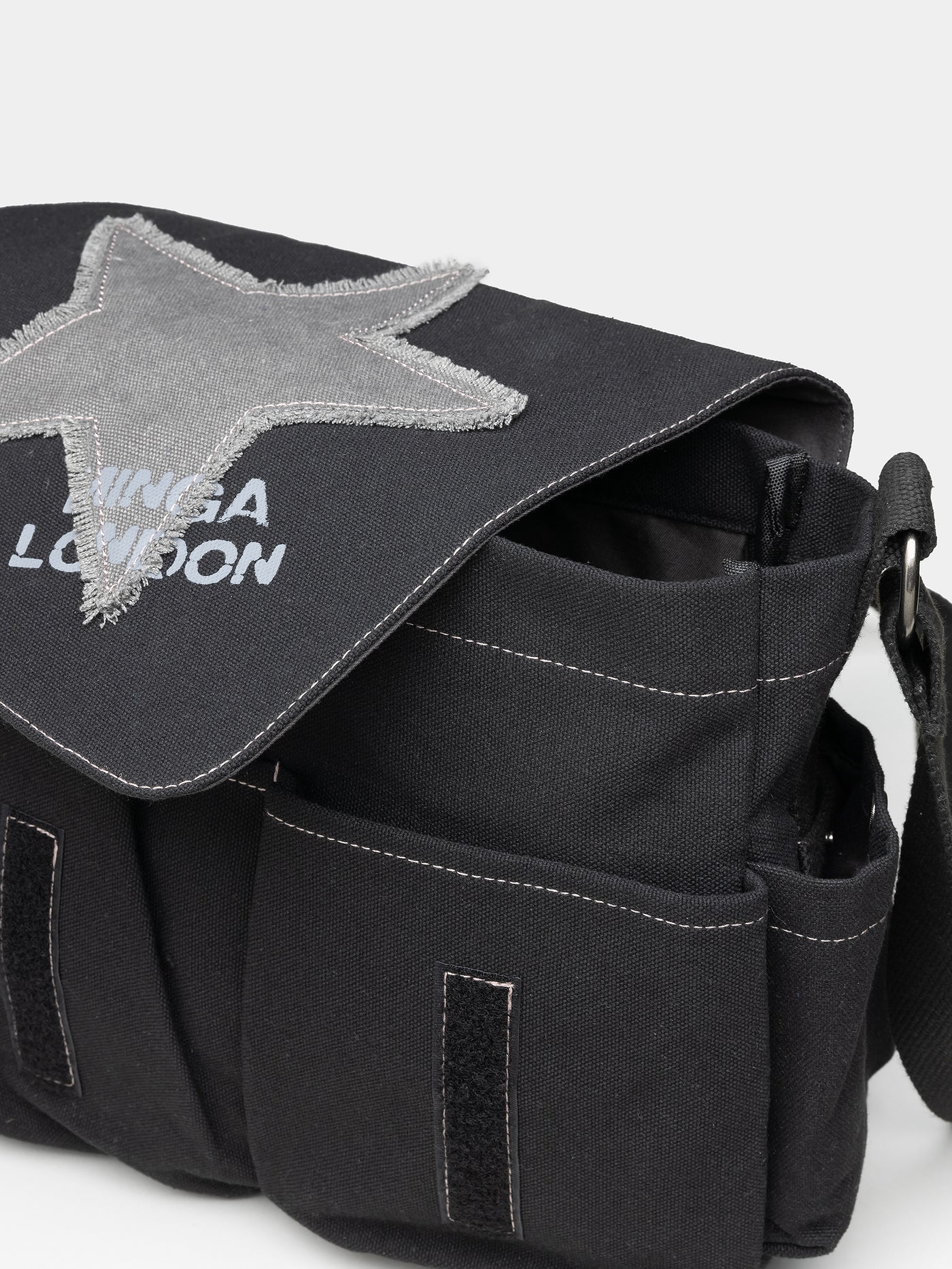 Grunge-inspired Y2K canvas messenger bag in washed black with Minga star front print in grey.