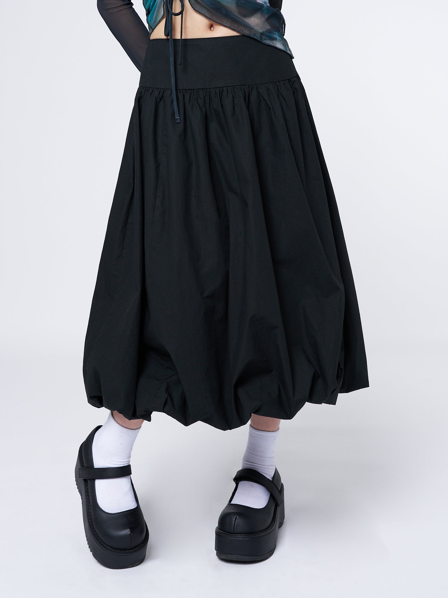 Black bubble midi skirt by Minga London. Flattering fit with playful silhouette. Versatile and stylish wardrobe essential.