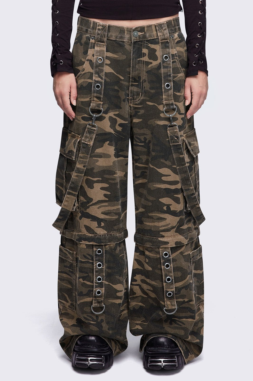 Camo multi pocket cargo jeans featuring a detachable-leg with zipper and all over straps and D-rings details.