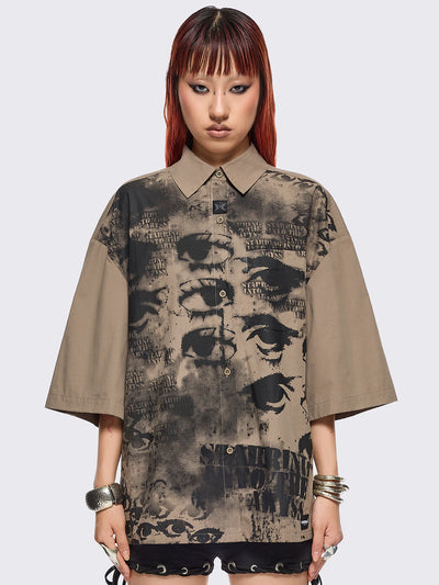 Stone short sleeve shirt featuring a black eyes and lettering graphic print, chest pocket, drop shoulders and oversize fit.