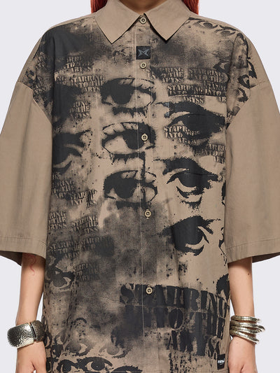 Stone short sleeve shirt featuring a black eyes and lettering graphic print, chest pocket, drop shoulders and oversize fit.