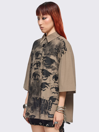 Stone short sleeve shirt featuring a black eyes and lettering graphic print, chest pocket, drop shoulders and oversize fit.