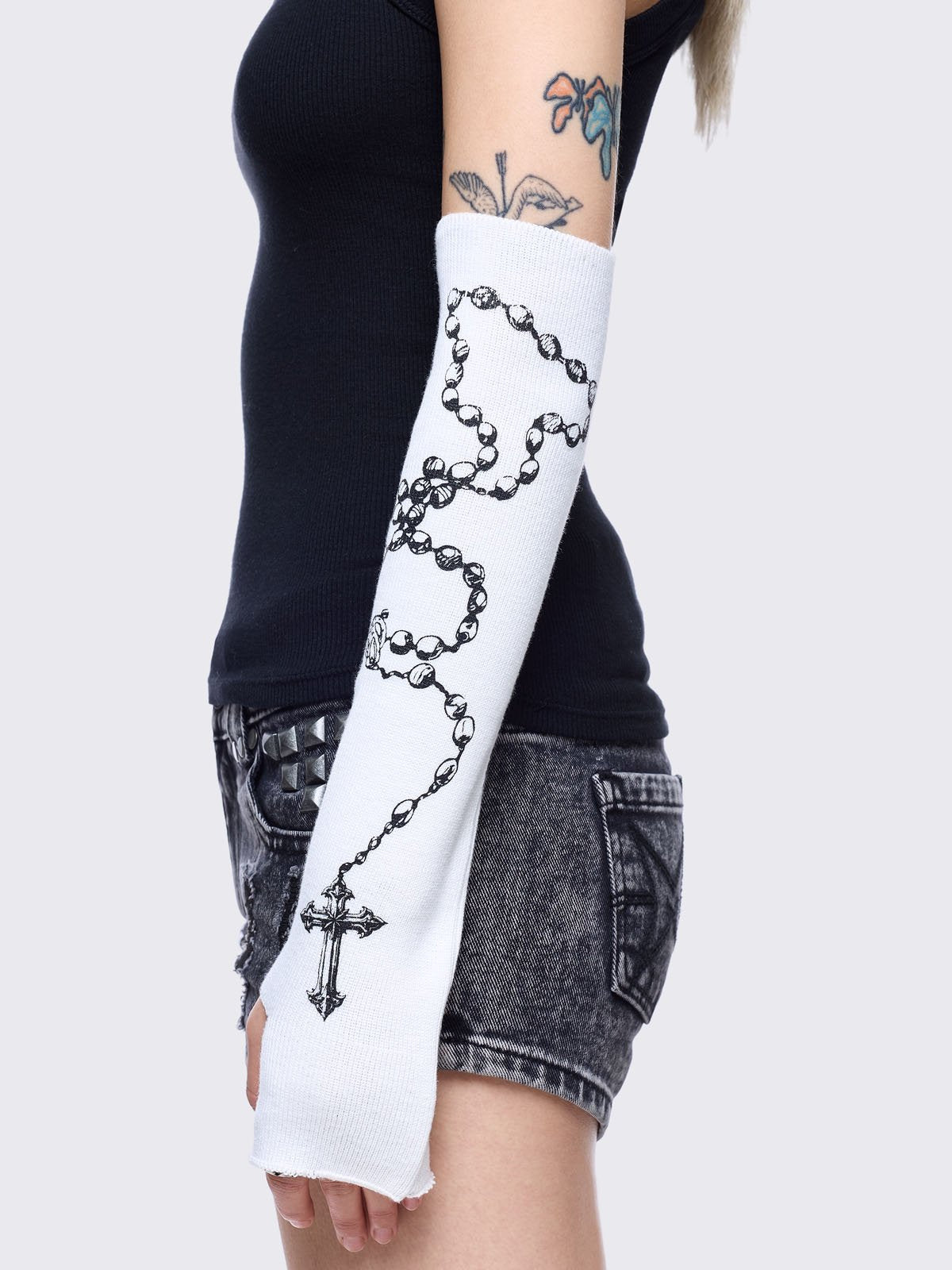 White knitted arm warmers with rosary and text graphic print.