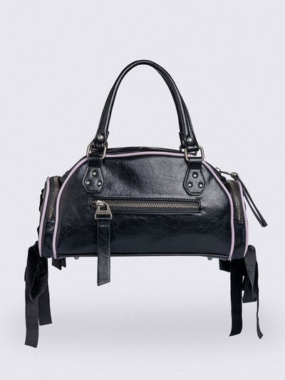 Black bowling bag with white wings graphic print, 3D cross metal stud and side exterior pockets with lace up bows.