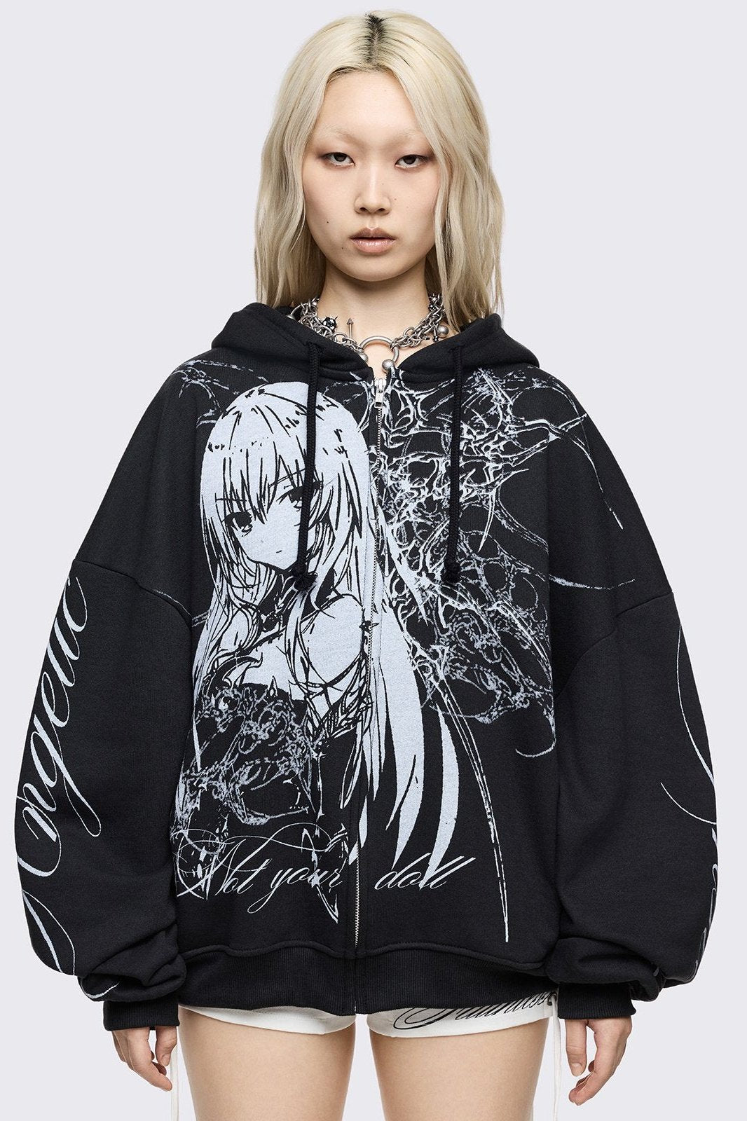 Black oversized zip up hoodie with "Not your doll" anime girl graphic front print and "Angelic insanity" print on sleeves.
