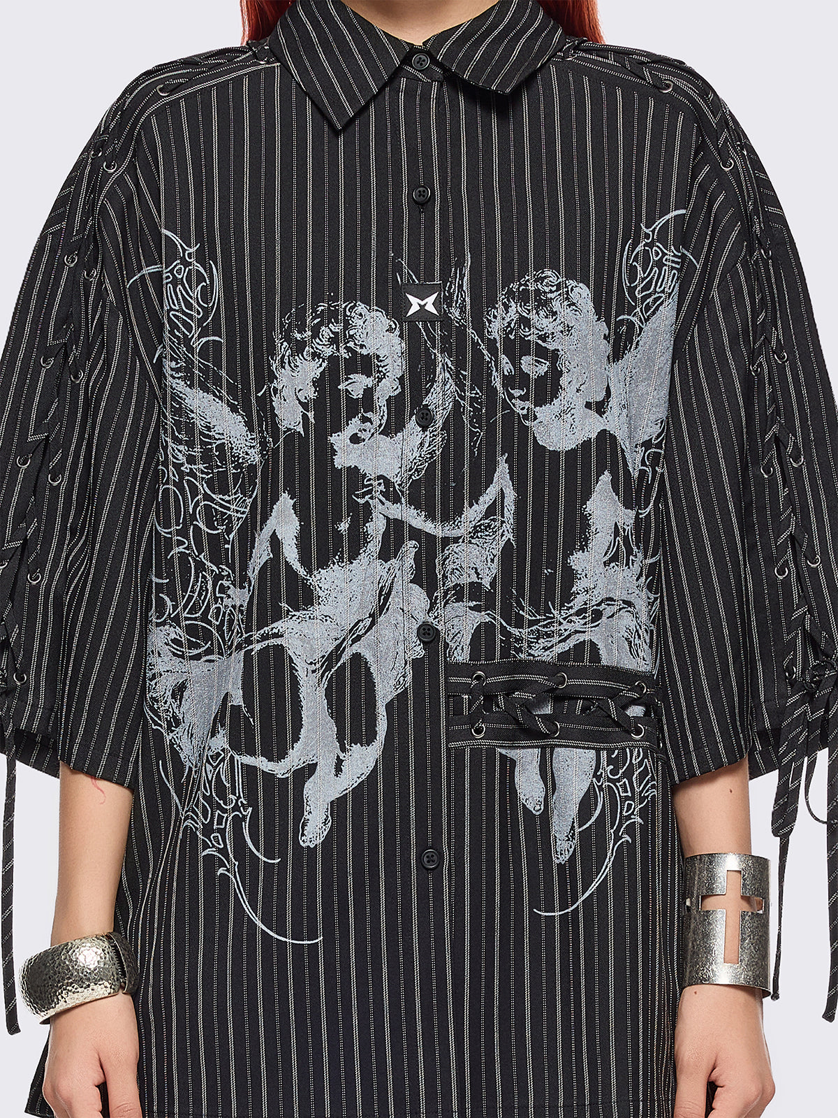 Black pinstriped shirt with white angels graphic front print and laced up details.