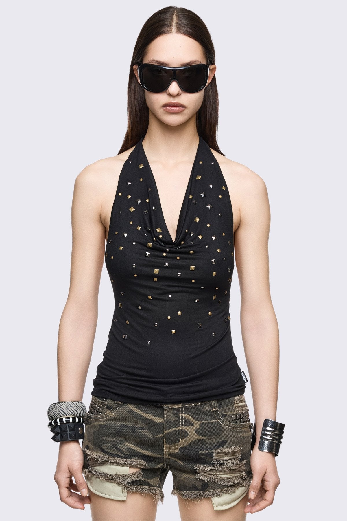 Black viscose halter top with mixed studs, draped cowl neck and open back in a grunge Y2K style.