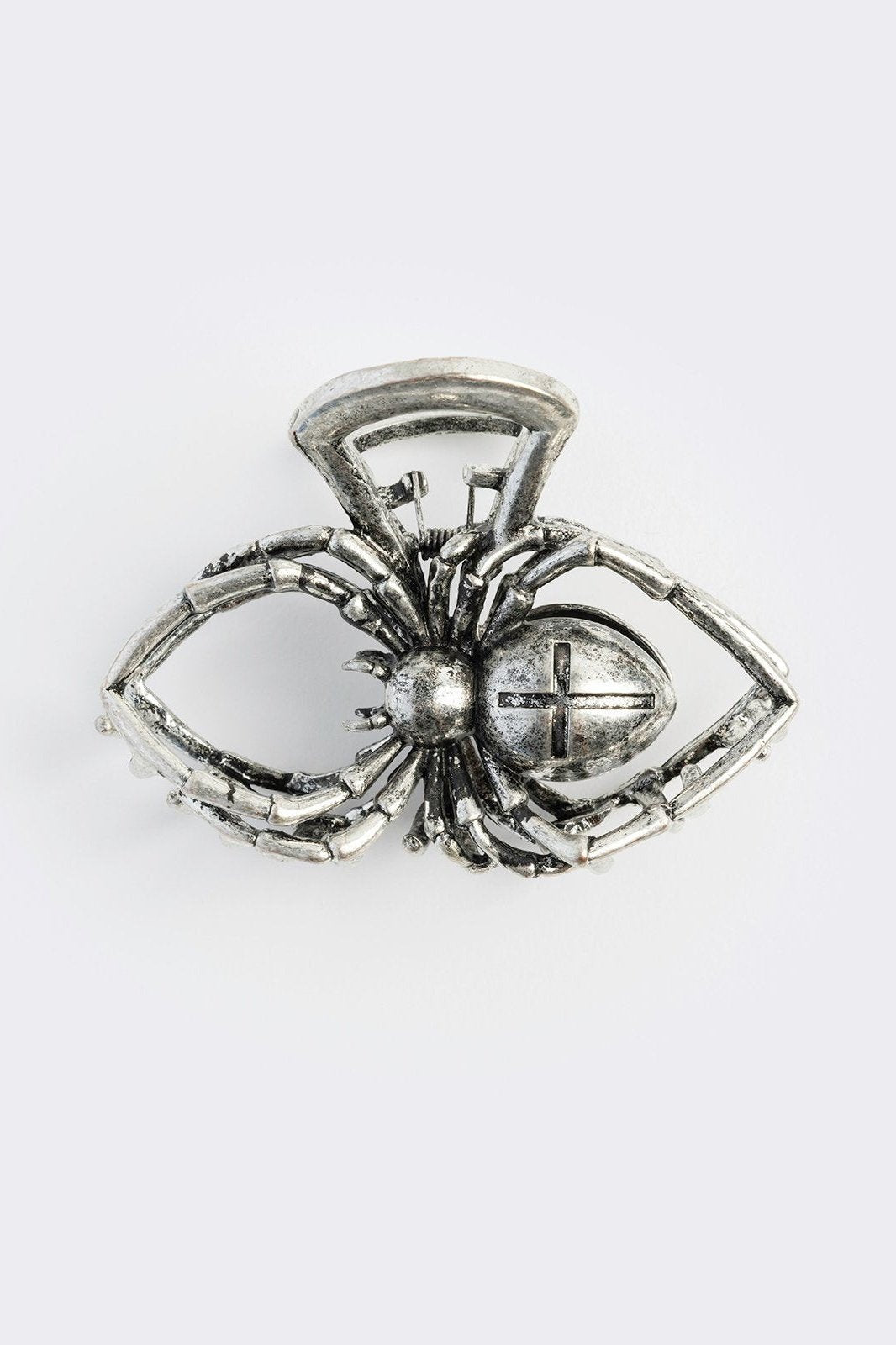 Metal hair claw clip with spider design.