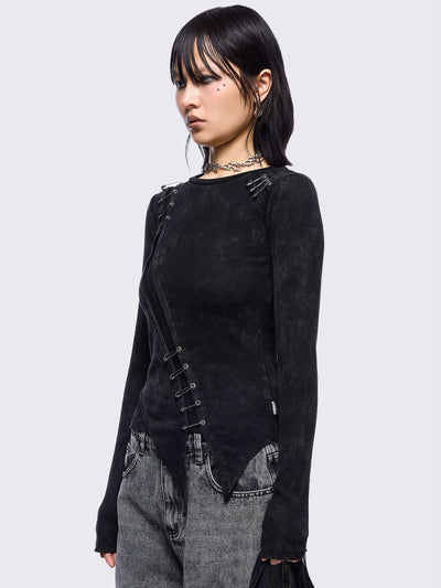 Black washed asymmetric top with cut-out and safety pin details.