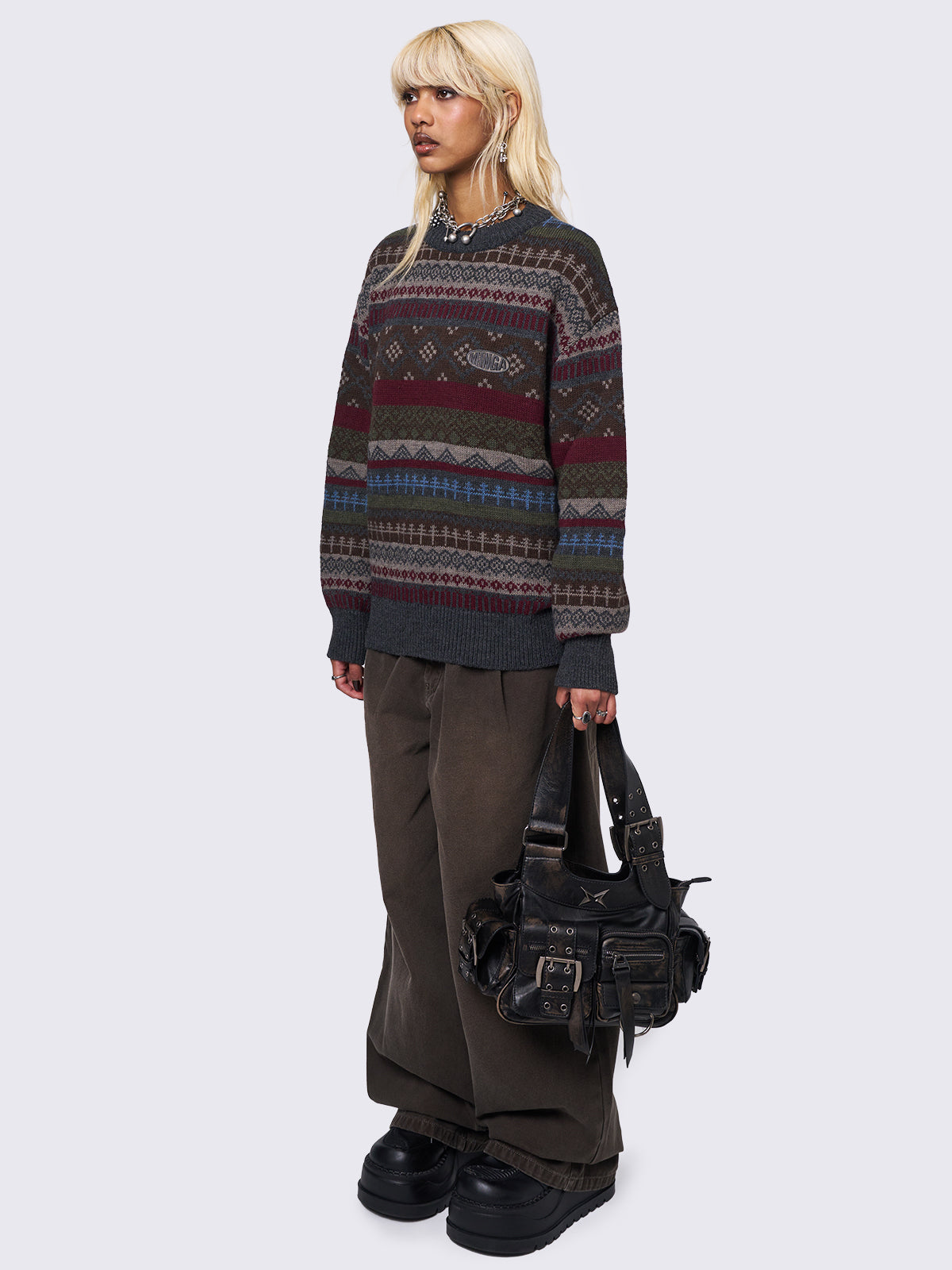 Jacquard knit jumper featuring geometric striped pattern in tones of grey, burgundy, green and blue.