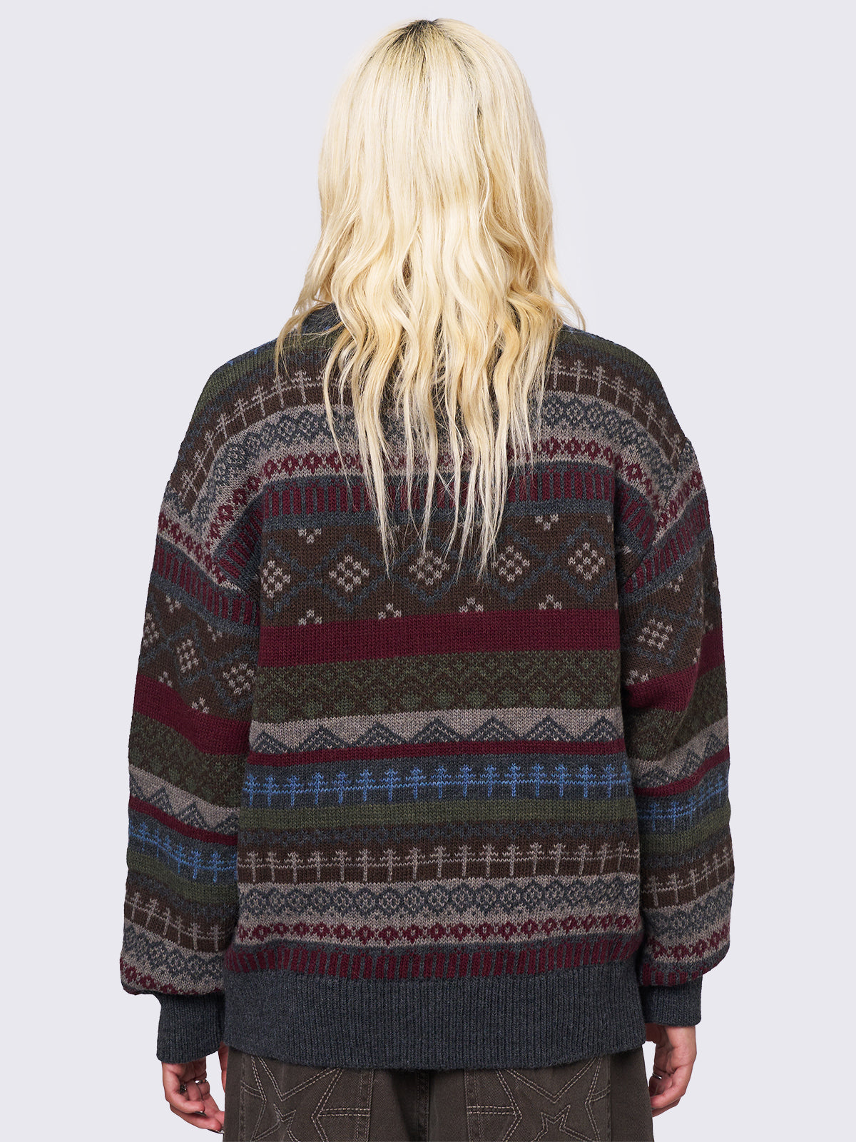 Jacquard knit jumper featuring geometric striped pattern in tones of grey, burgundy, green and blue.