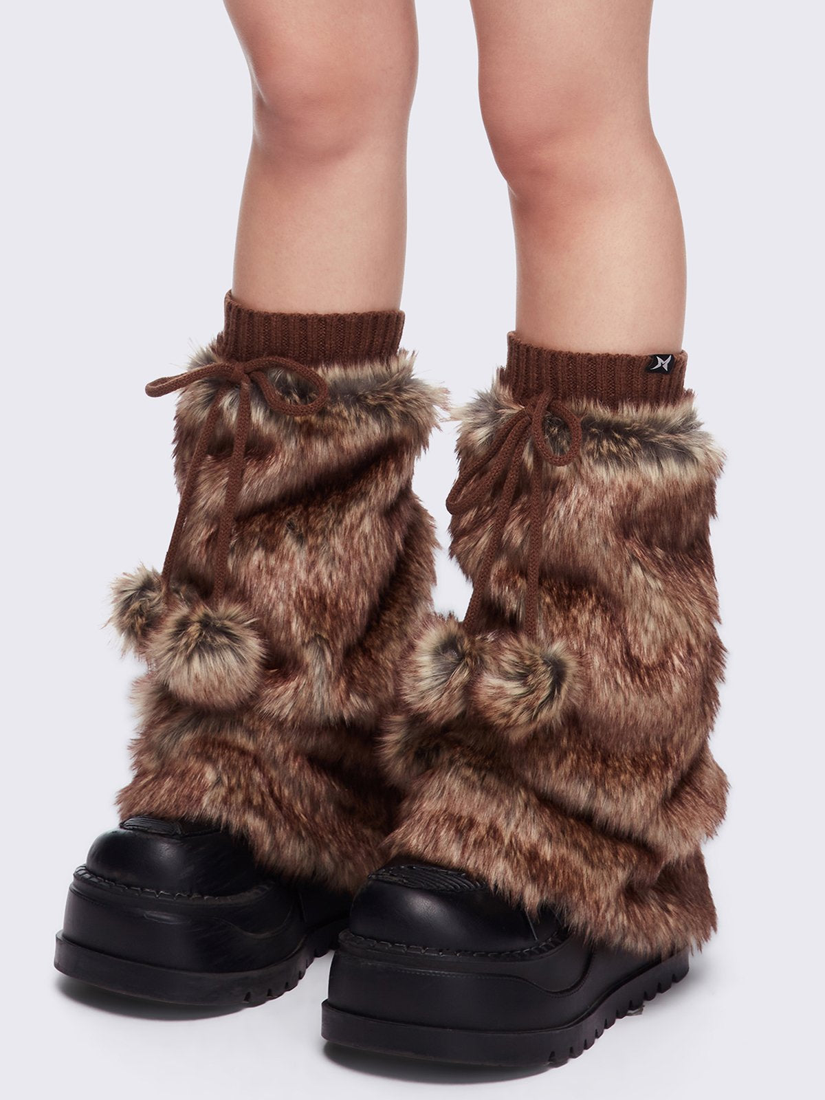 Brown faux fur flared leg warmers with pom pom drawstring.