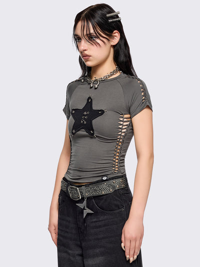 Grey slitweave baby tee with black front star patch with piercings.