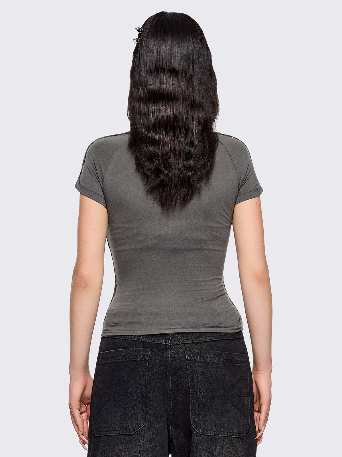 Grey slitweave baby tee with black front star patch with piercings.