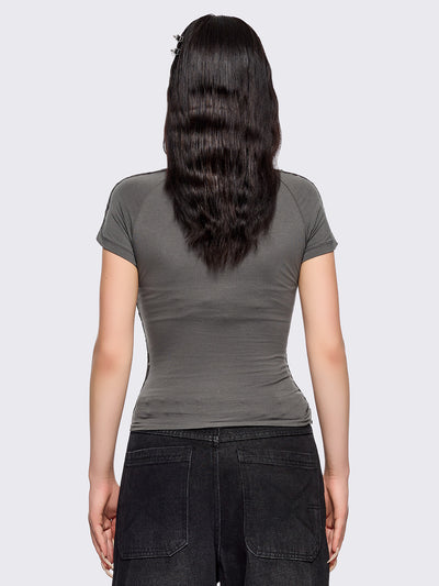 Grey slitweave baby tee with black front star patch with piercings.